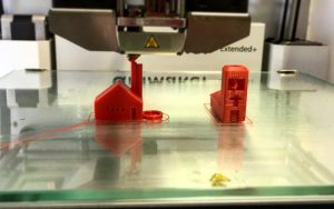 3D printer laying down the first layer on the build plate