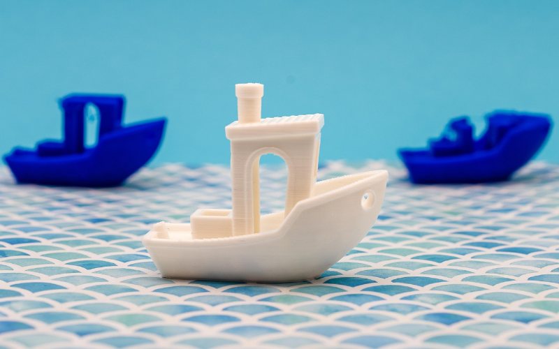 3D printed boats showing curved unsupported surfaces