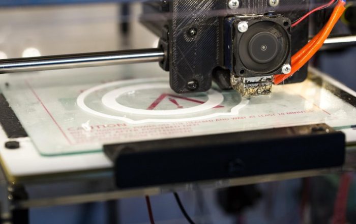 White 3D printed model on a printer build plate